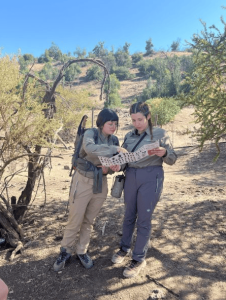 Dos de nuestras mujeres guardaparques observando folleto sobre fauna y flora de Parque Cordillera